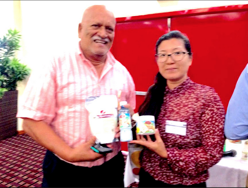 Photo (shows Beni Sankar and his business partner May Cheung displaying some of their coconut products) courtesy of Stabroek News]